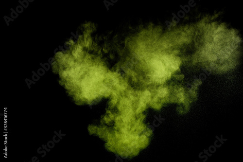 Light green powder explosion on black background. Colored powder cloud. Colorful dust explode. Paint Holi.