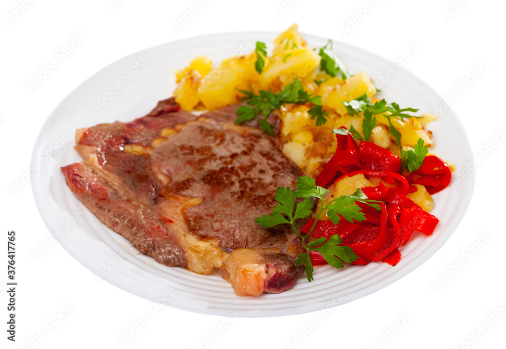 Fototapeta premium Homemade veal steak with fried potato and marinated red pepper. Isolated over white background