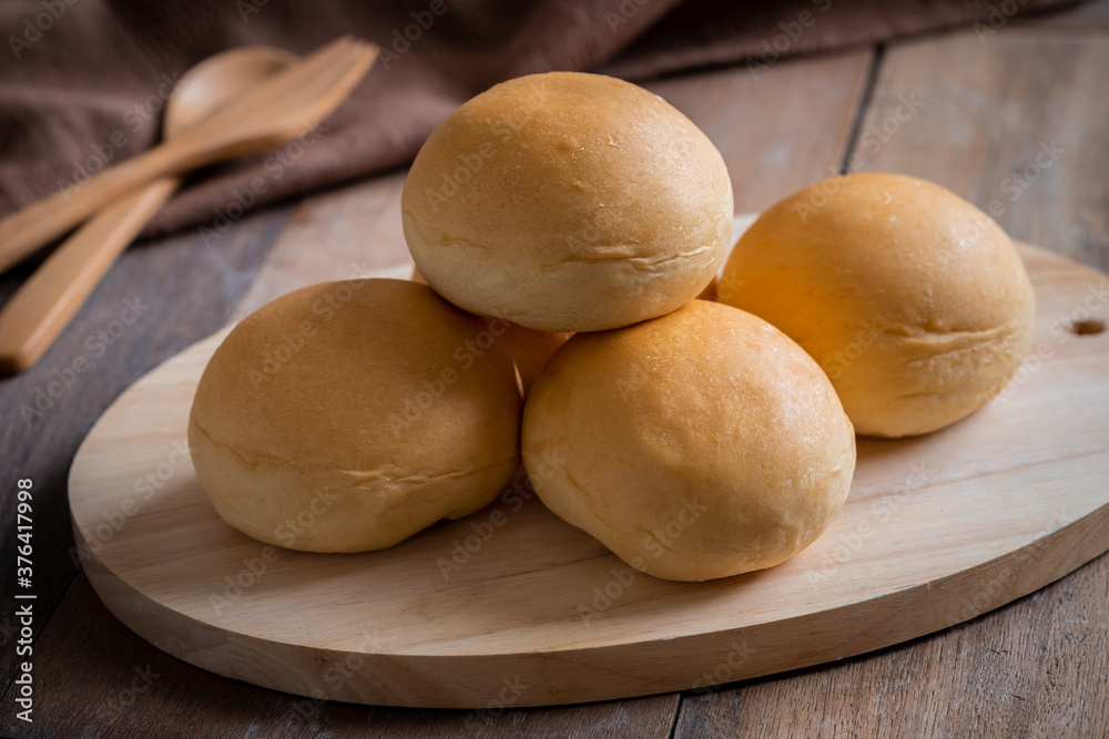 Bread roll or bun on wooden board. Bread roll or bun on wooden board.