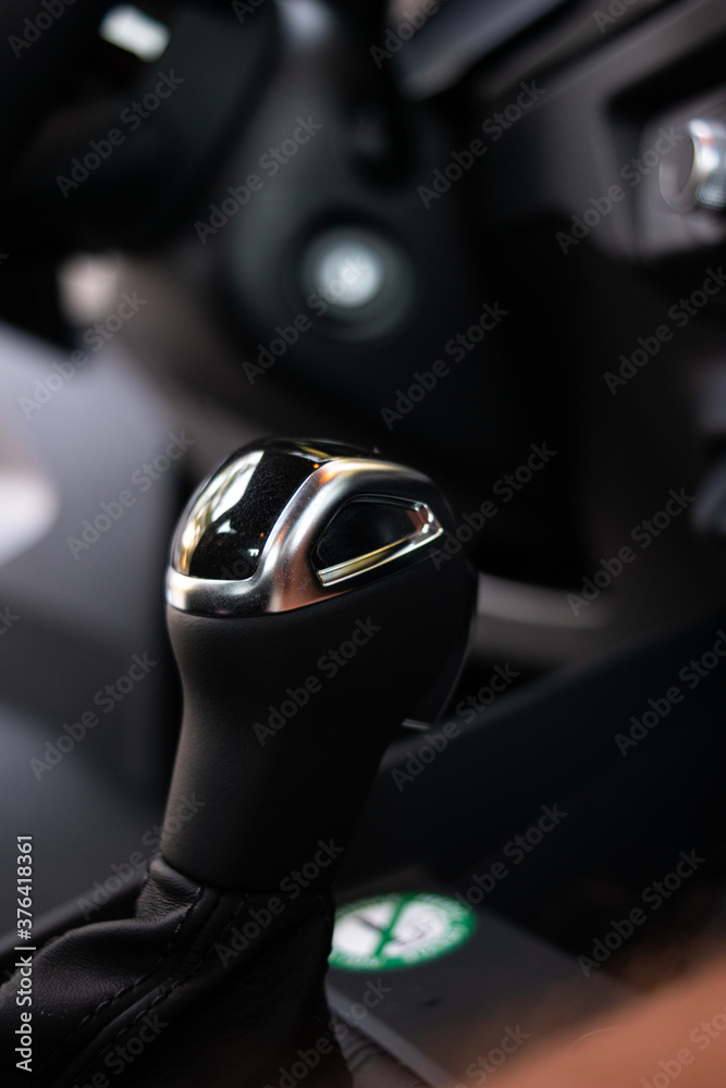 Generic black plastic car gear shit knob and metal decoration on top close up shot shallow depth of field Generic black plastic car gear shit knob and metal decoration on top close up shot shallow depth of field