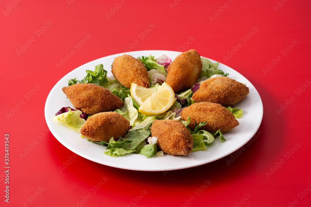 Traditional lebanese kibbeh on red background Traditional lebanese kibbeh on red background