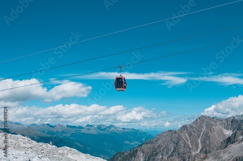 A cable car in the mountains on the italian Alps above clouds (Trentino, Italy, Europe)