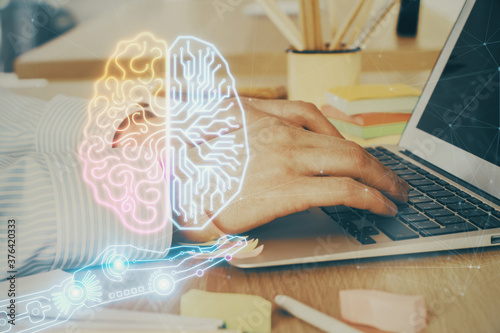 Man typing on keyboard background with brain hologram. Concept of big Data. Double exposure.