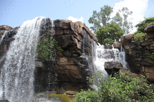 Fototapeta Naklejka Na Ścianę i Meble -  Water fall in Mirzapur, India. Landscape shot of a beautiful waterfall, located in India with selective focus. Watre if falling from a cliff.