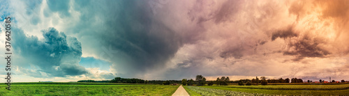 Stormy and dramatic sky panorama of rural area.