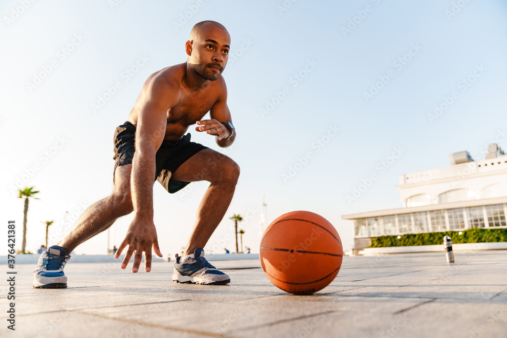 Image of african american sportsman doing exercise while working out Image of african american sportsman doing exercise while working out