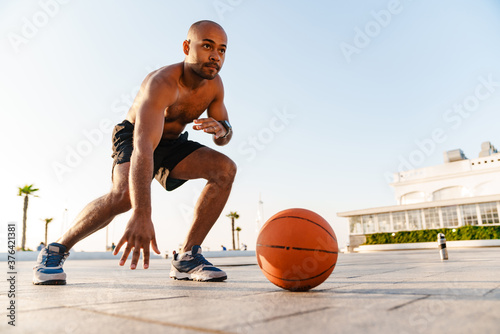 Image of african american sportsman doing exercise while working out © Drobot Dean