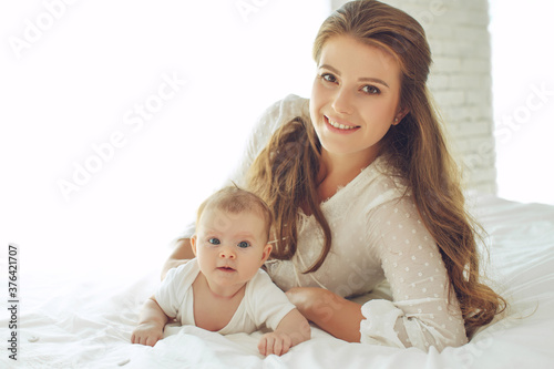 Small child with a woman. Baby with mom. High quality photo.