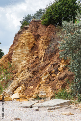 Landslide zone on Black Sea coast. Rock of sea rock shell. Zone of natural disasters during rainy season. Large masses of earth slip along slope of hill, destroy houses. Landslide - threat to life
