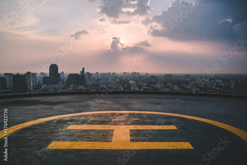 Helipad sunset Bangkok, Thailand, rooftop helicopter, top of the building, skyline, helicopter landing area in the city photo