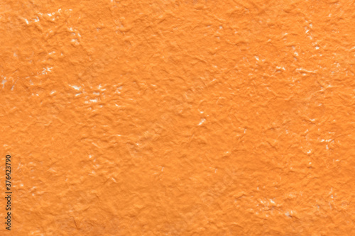 Close-up of orange crumpled paper, texture background