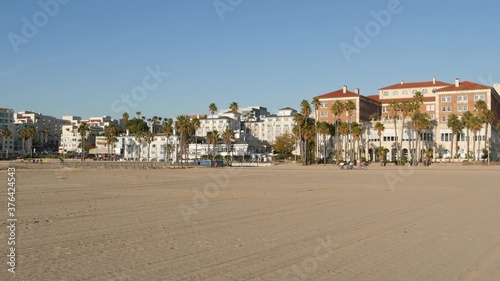 California summertime beach aesthetic, sunny blue sky, sand and many different beachfront weekend houses. Seafront buildings, real estate in Santa Monica pacific ocean resort near Los Angeles CA USA