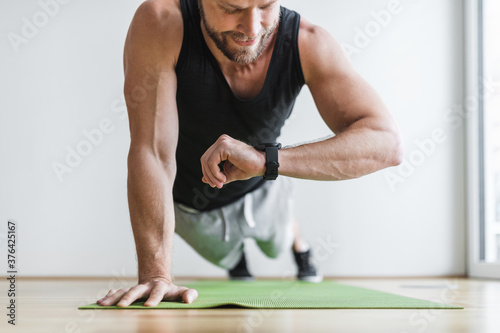 Handsome man working out at home