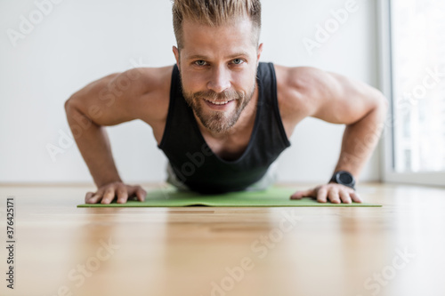 Handsome man working out at home