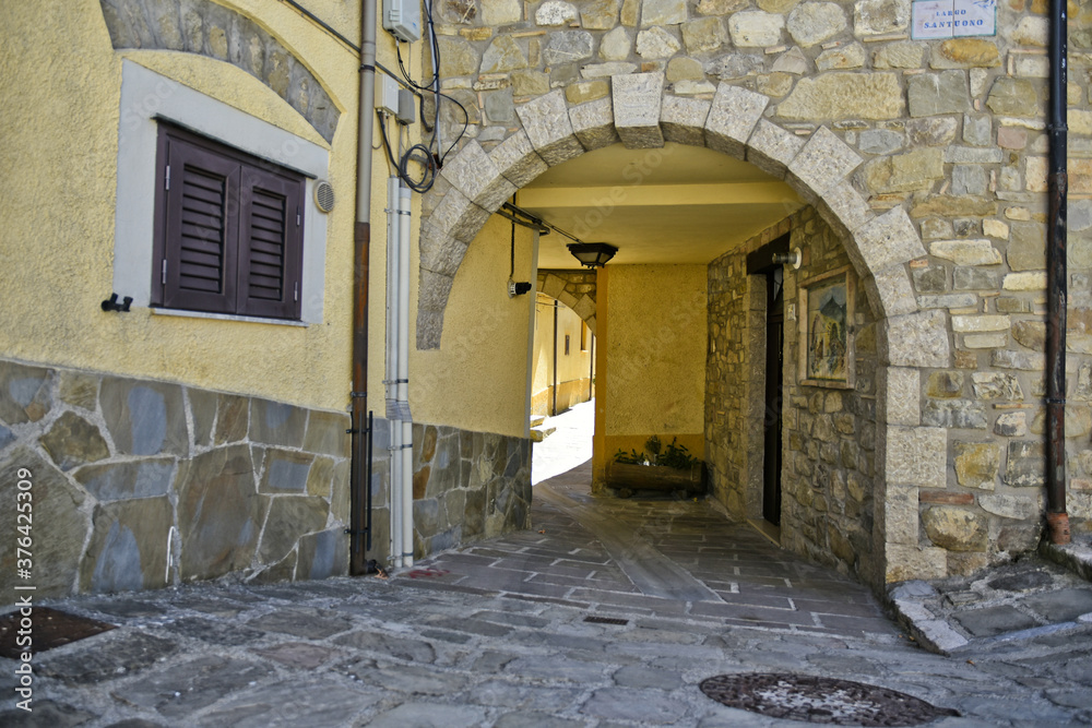 Fototapeta premium A small road crosses the old buildings of Calvello, a old Town in the Basilicata region, Italy.