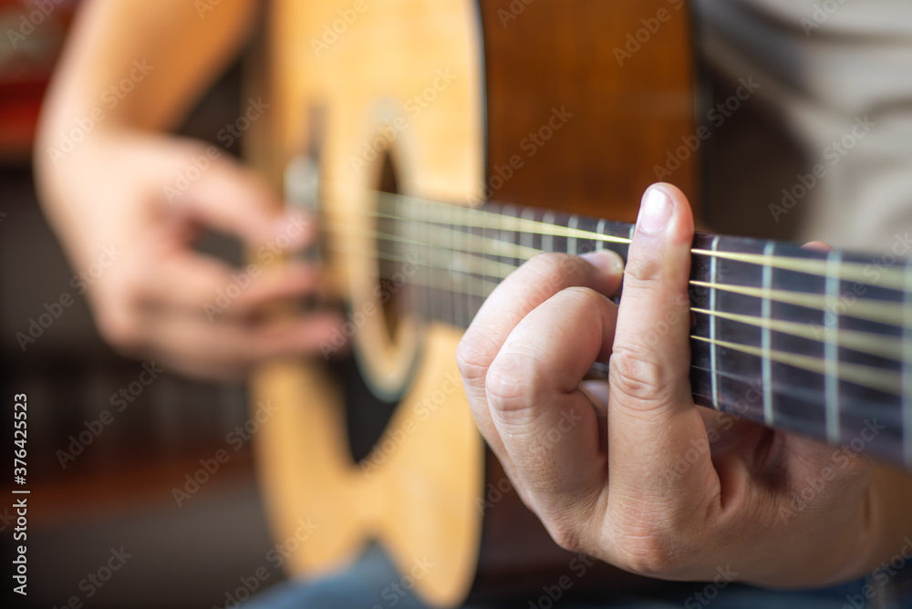Fototapeta premium man playing acoustic guitar