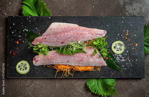 Delicious fresh fish on dark  background photo