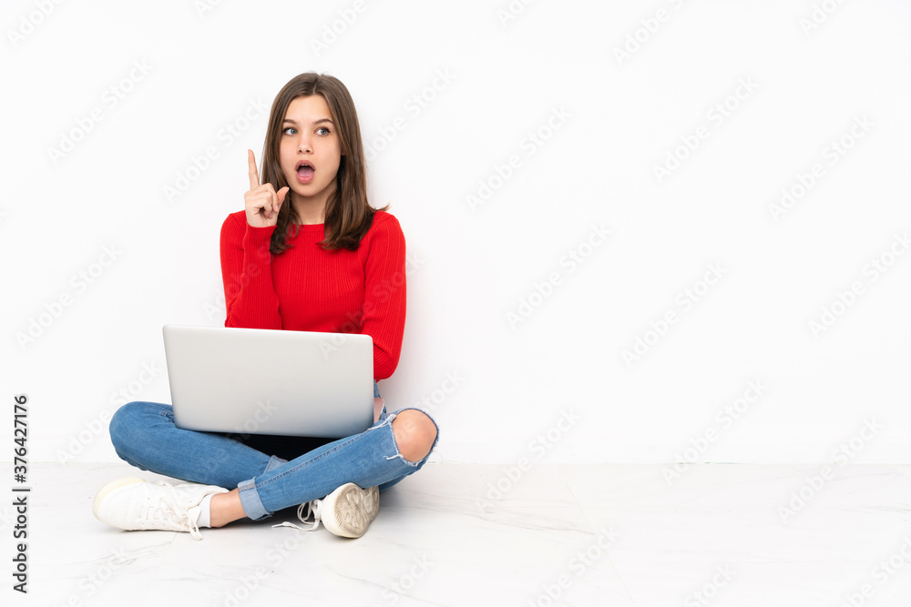 Tenaager girl working with pc isolated on white background thinking an idea pointing the finger up Tenaager girl working with pc isolated on white background thinking an idea pointing the finger up