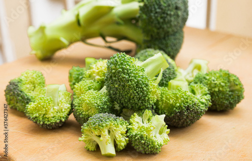 resh appetizing broccoli inflorescences on wooden board