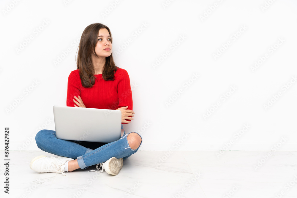 Tenaager girl working with pc isolated on white background in lateral position Tenaager girl working with pc isolated on white background in lateral position