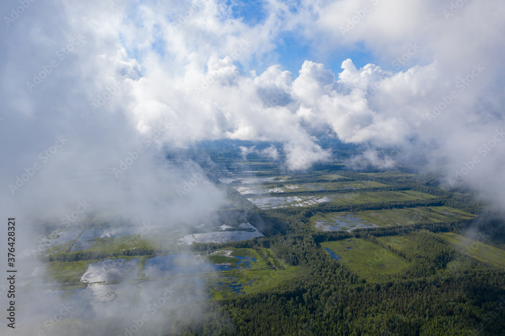 Aerial view of flooded Seda swamp (Sedas purvs) water lakes through low clouds Aerial view of flooded Seda swamp (Sedas purvs) water lakes through low clouds