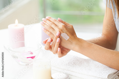 Skin care, woman wears moisturizer on skin