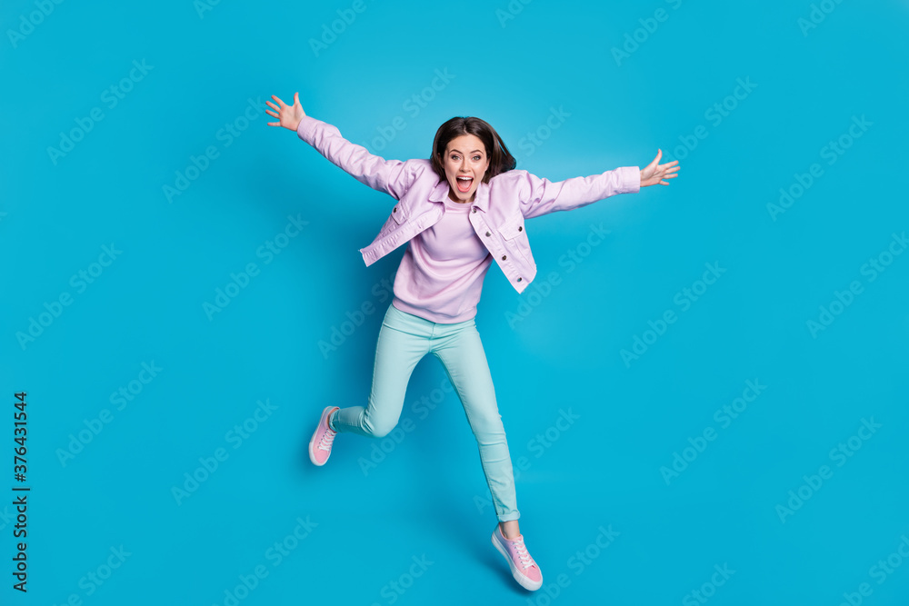 Full length body size view of nice attractive funky girlish childish playful energetic motivated cheerful girl jumping having fun motion isolated on bright vivid shine vibrant blue color background