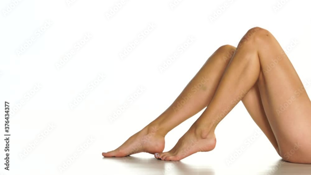 nicely groomed female legs on a white background nicely groomed female legs on a white background