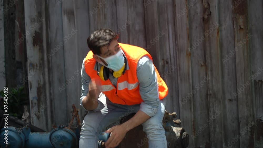 furious young worker about to throw and break helmet and face mask at workplace. engineer unemployment during corona virus pandemic . factory shutdown by covid 19 outbreak . furious young worker about to throw and break helmet and face mask at workplace. engineer unemployment during corona virus pandemic . factory shutdown by covid 19 outbreak .