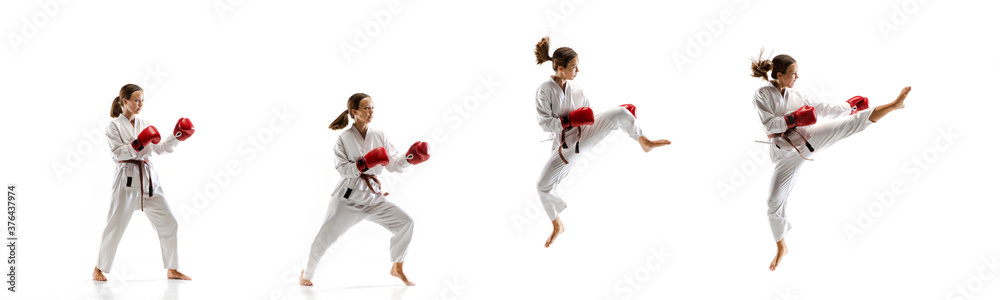 Punching. Junior in kimono practicing taekwondo combat, martial arts. Young female fighter with red gloves training on white studio background in motion, dymanic. Concept of healthy lifestyle, action. Punching. Junior in kimono practicing taekwondo combat, martial arts. Young female fighter with red gloves training on white studio background in motion, dymanic. Concept of healthy lifestyle, action.