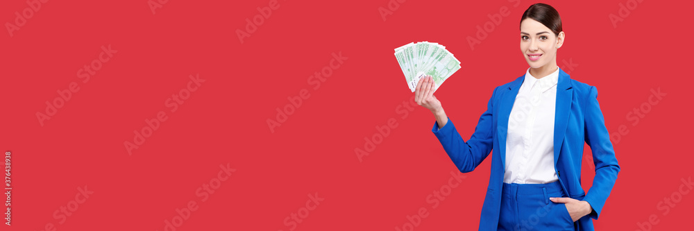 Business woman holding money and showing product, caucasian female wearing blue suit with cash, smiling girl touch euro banknotes on red isolated background Business woman holding money and showing product, caucasian female wearing blue suit with cash, smiling girl touch euro banknotes on red isolated background