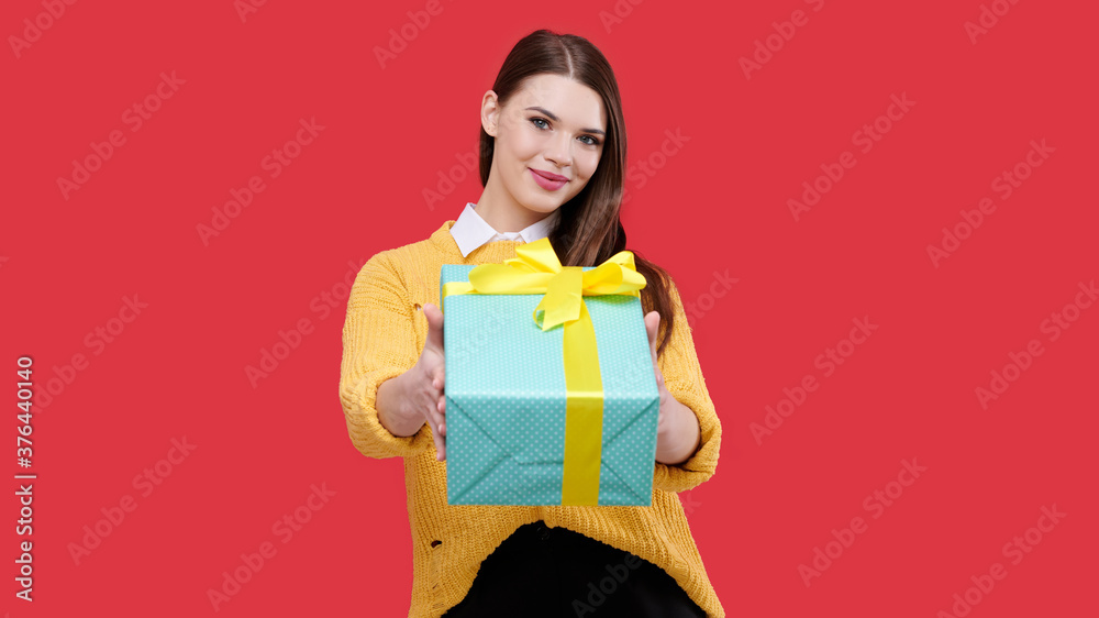 Happy woman holding gift on red isolated background, girl with present, female with birthday box, selebrating christmass, party Happy woman holding gift on red isolated background, girl with present, female with birthday box, selebrating christmass, party