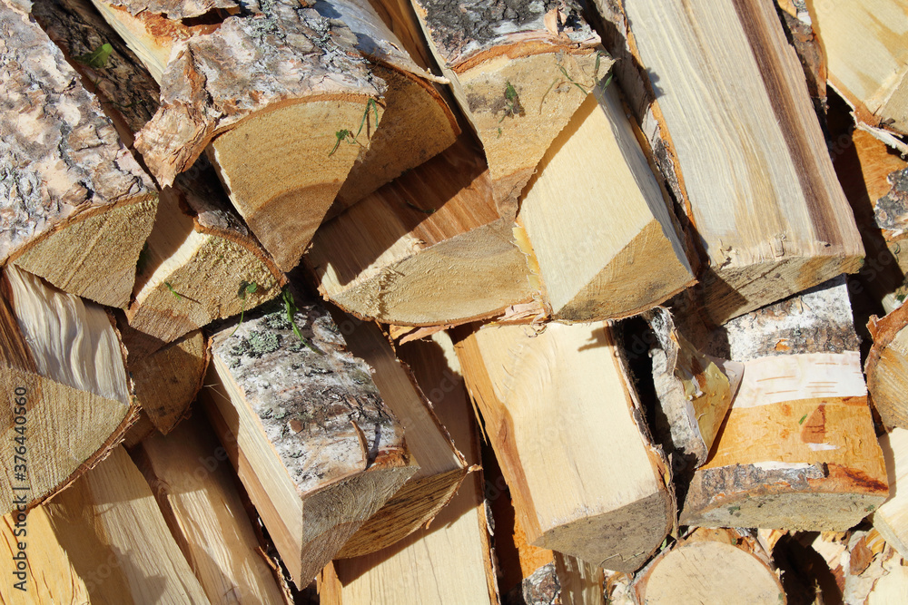 Woodpile of birch firewood. Close-up. Background. Texture. Woodpile of birch firewood. Close-up. Background. Texture.