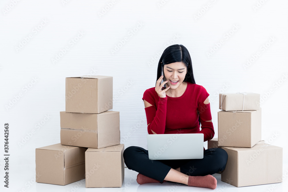 Asian attractive woman using a mobile phone and notebook computer Talk to customers who order online, concept to people Running a business to sell products online or SME, Entrepreneur Asian attractive woman using a mobile phone and notebook computer Talk to customers who order online, concept to people Running a business to sell products online or SME, Entrepreneur