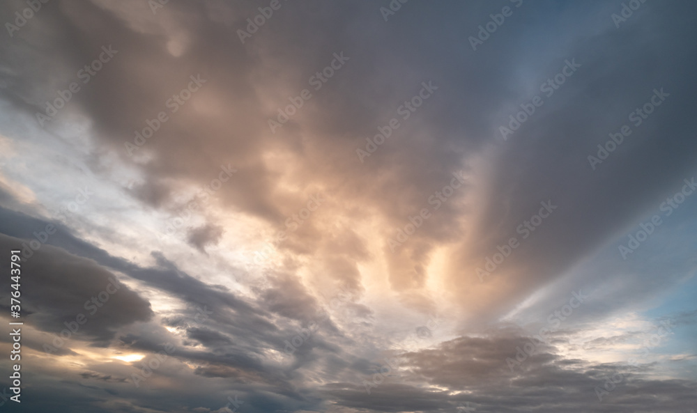 Fluffy clouds in evening overcast sky view. Climate, environment and weather concept sky background.