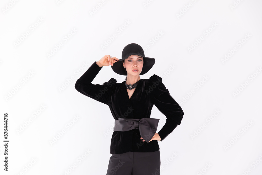 Young girl female model brunette in black hat on white background Young girl female model brunette in black hat on white background
