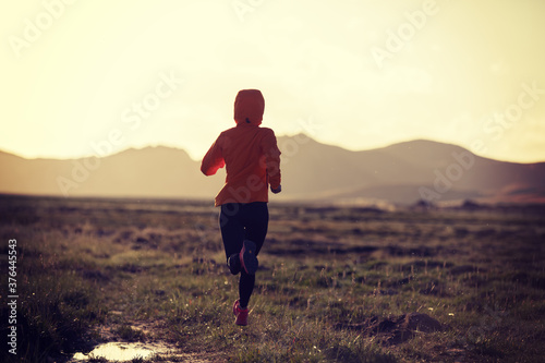 Woman trail runner cross country running outdoors