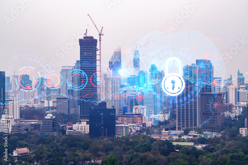 Padlock icon hologram over panorama city view of Bangkok to protect business in Asia. The concept of information security shields. Double exposure.