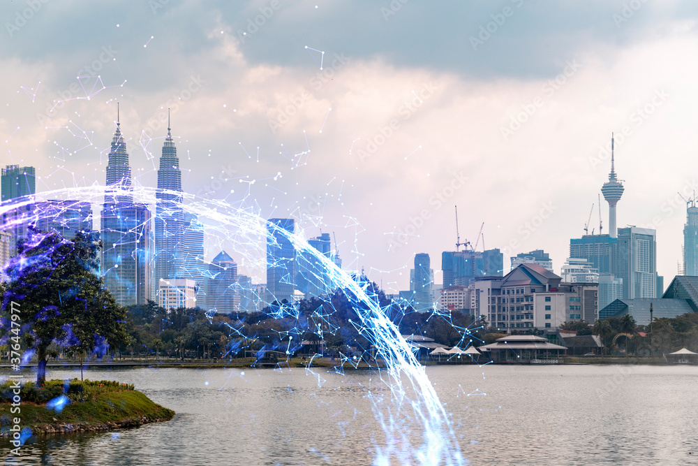 Obraz premium Hologram of abstract technology glowing icons, panoramic cityscape of Kuala Lumpur at sunset, Malaysia, Asia. The concept of worlds technological changes. Double exposure.