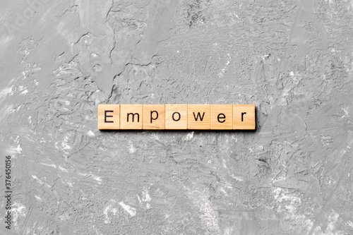 empower word written on wood block. empower text on table, concept