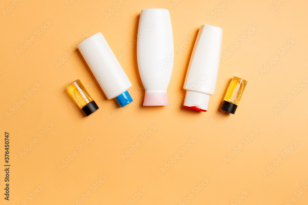 Cosmetics SPA branding mock-up, top view with copy space. set of tubes and jars of cream flat lay on colored background Cosmetics SPA branding mock-up, top view with copy space. set of tubes and jars of cream flat lay on colored background