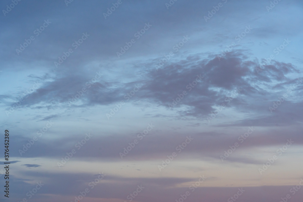 blue evening sky with purple and gray clouds. wonderful calm blue sky.