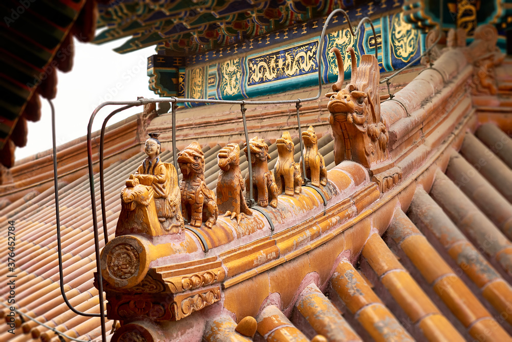Fototapeta premium close up of antique traditional Chinese roof figurines. Architectural background. Imperial Summer Palace. Beijing