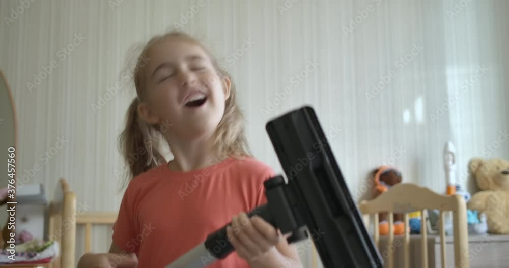 Little Fun Creative Girl Singing and Using Мacuum Сleaner Handle as Microphone. Child Using Mop as Guitar While Singing in Play Room. Enjoying Spring Cleaning. Playful Creative Kid Dancing With Mop. Little Fun Creative Girl Singing and Using Мacuum Сleaner Handle as Microphone. Child Using Mop as Guitar While Singing in Play Room. Enjoying Spring Cleaning. Playful Creative Kid Dancing With Mop.