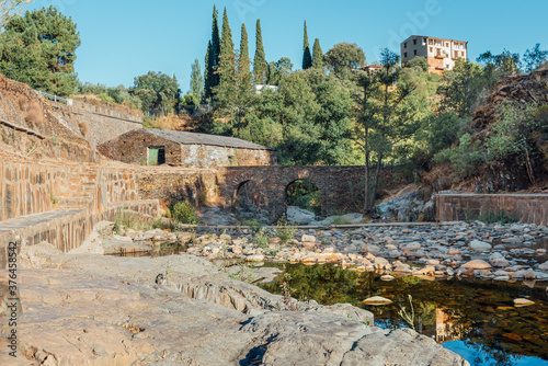 Roman bridge and natural pool in Las Mestas, Caceres, Extremadura, Spain photo