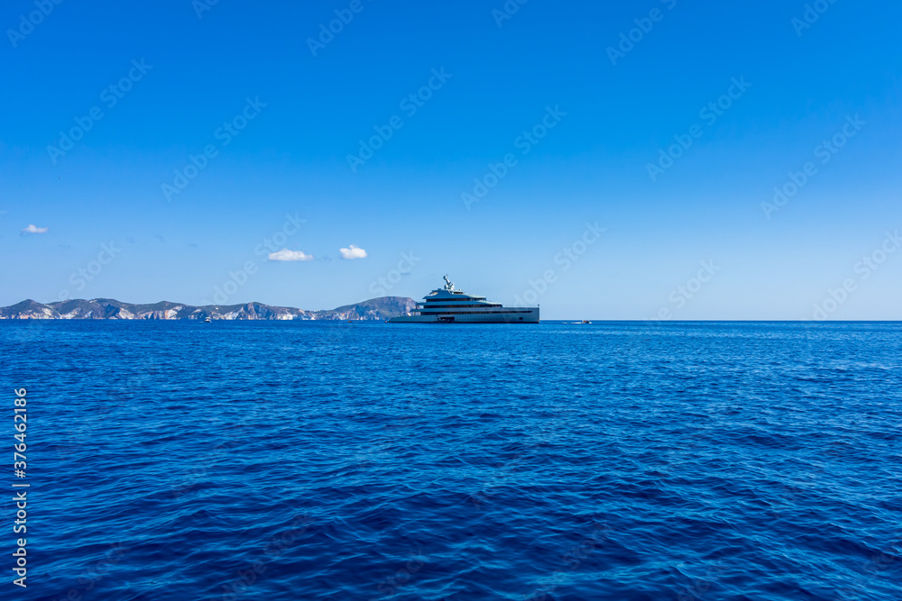 View of the Ponza island with a wonderful luxury yacht in the foreground (Latina, Italy).