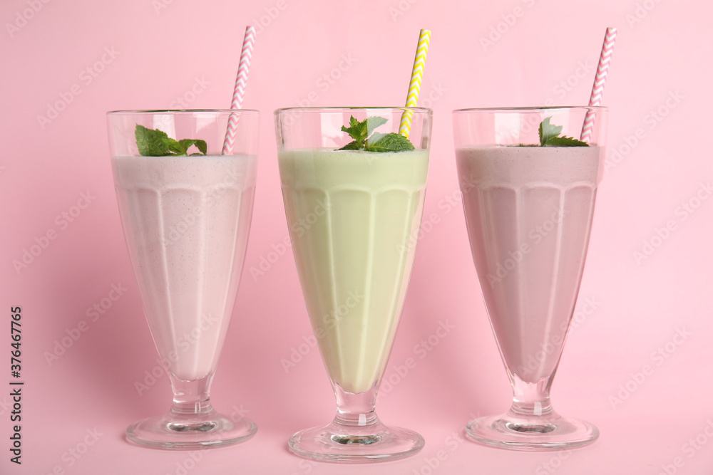 Tasty fresh milk shakes on pink background Tasty fresh milk shakes on pink background