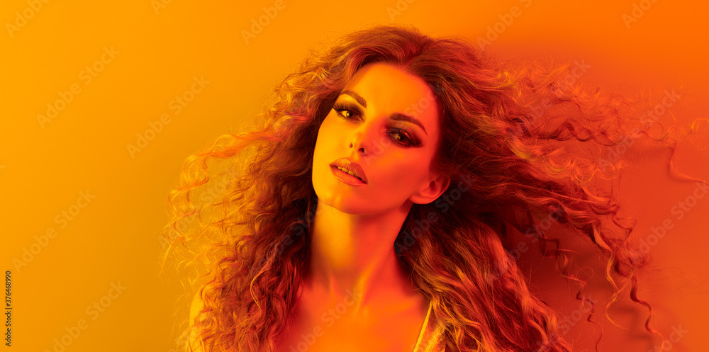Fashion. Woman in colorful neon gold light, make-up. Beautiful blond girl, stylish curly hair, trendy makeup. Golden portrait. Creative beauty, fashionable model face, voluminous hairstyle Fashion. Woman in colorful neon gold light, make-up. Beautiful blond girl, stylish curly hair, trendy makeup. Golden portrait. Creative beauty, fashionable model face, voluminous hairstyle