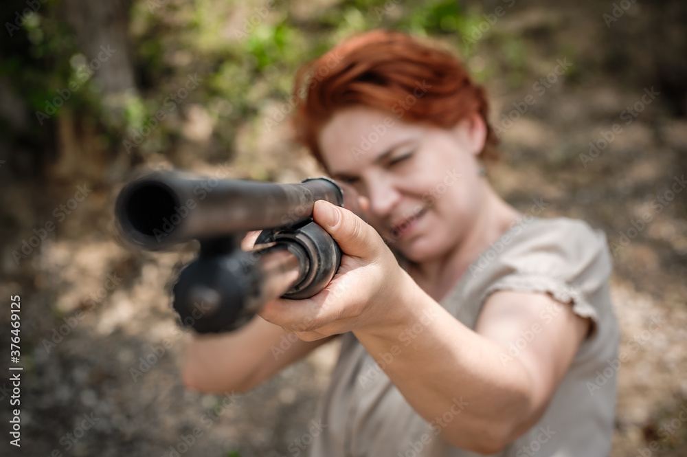 Woman shooting with pump gun. Direct macro detail close-up shotgun front view gun point. Firearm shooting and weapons training. Shooting range Woman shooting with pump gun. Direct macro detail close-up shotgun front view gun point. Firearm shooting and weapons training. Shooting range