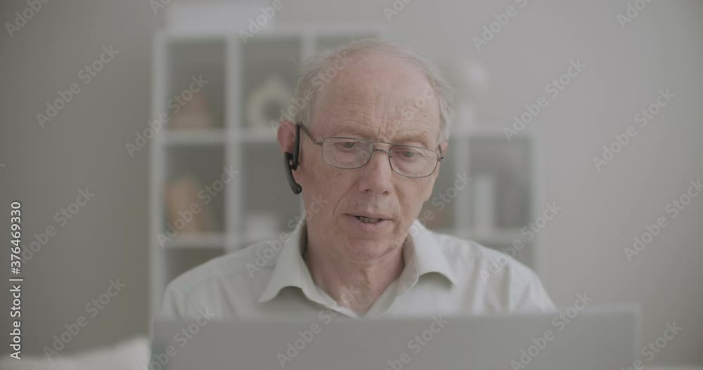 portrait of retiree man is chatting online by video call on laptop, stay home at pandemic of coronavirus